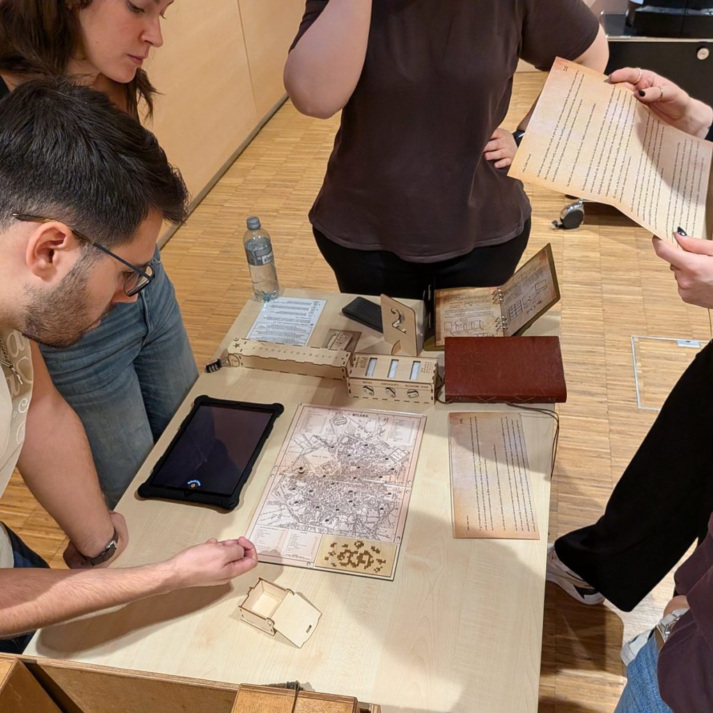 Team solving the Vinci Challenge map puzzle with wooden boxes and tablet – corporate events in Switzerland